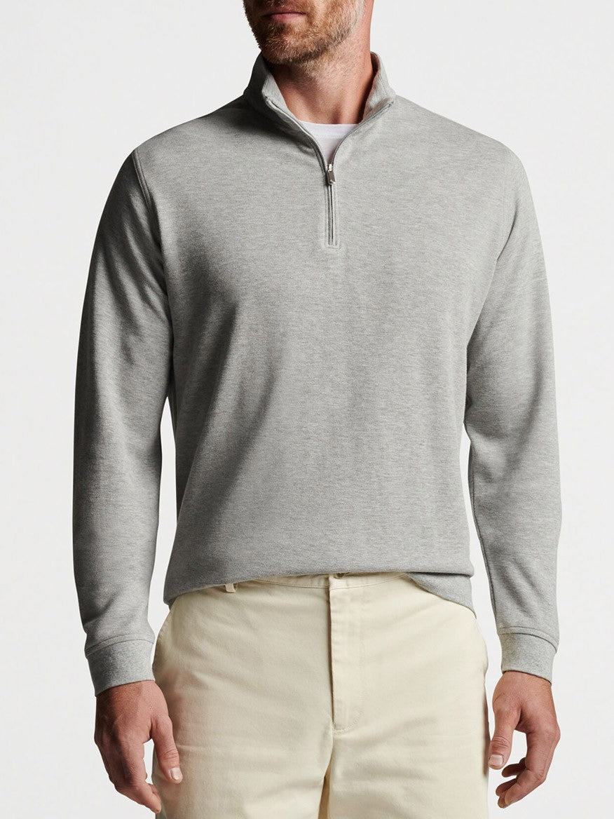 A man wearing a Peter Millar Crown Comfort Pullover in Light Grey.