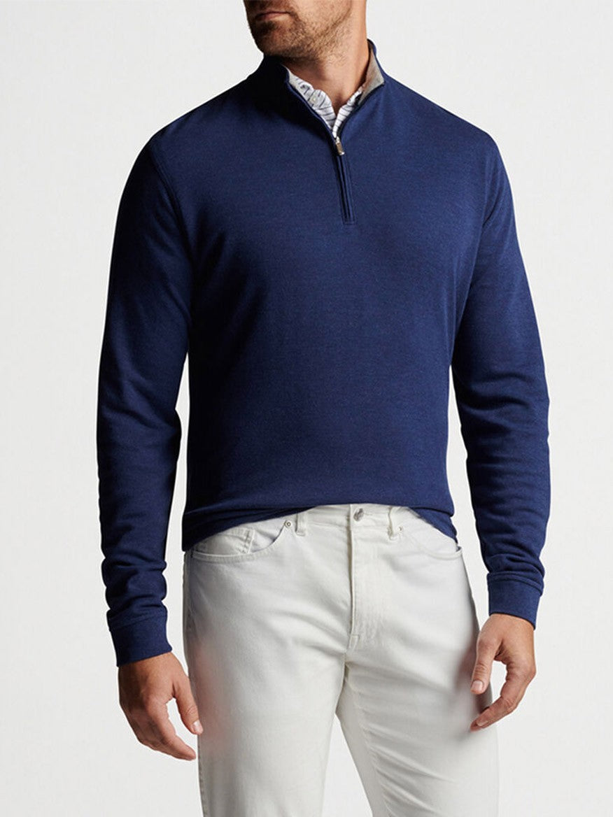 A man wearing a Peter Millar Crown Comfort Pullover in Navy made of a soft cotton blend material.