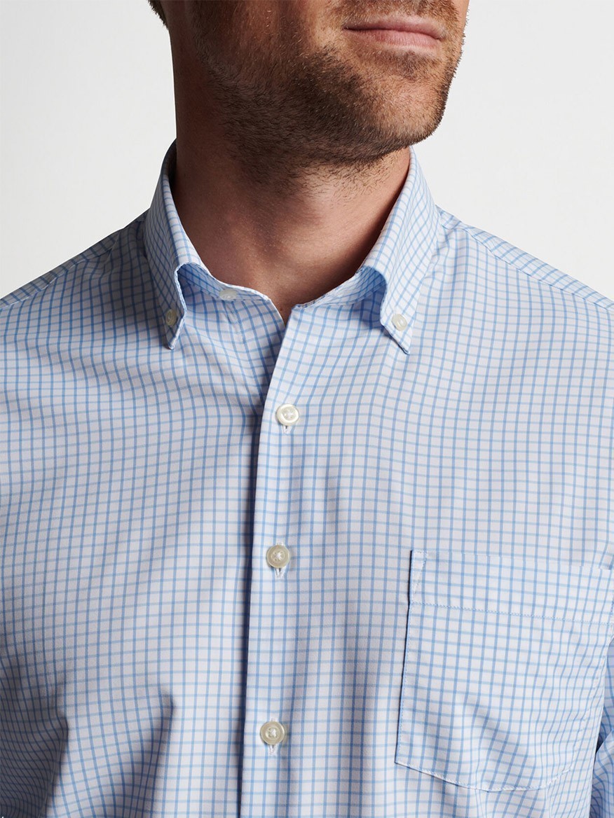 Close-up of a man wearing a Peter Millar Hanford Performance Twill Sport Shirt in Cottage Blue with UPF 50+ protection.