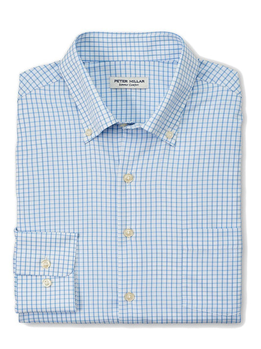 A folded blue and white checkered dress shirt with the Peter Millar Hanford Performance Twill Sport Shirt in Cottage Blue label, designed in a performance style and featuring UPF 50+ protection.