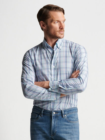 A man wearing jeans and a Peter Millar Caspian Cotton Sport Shirt in Multi made of cotton.
