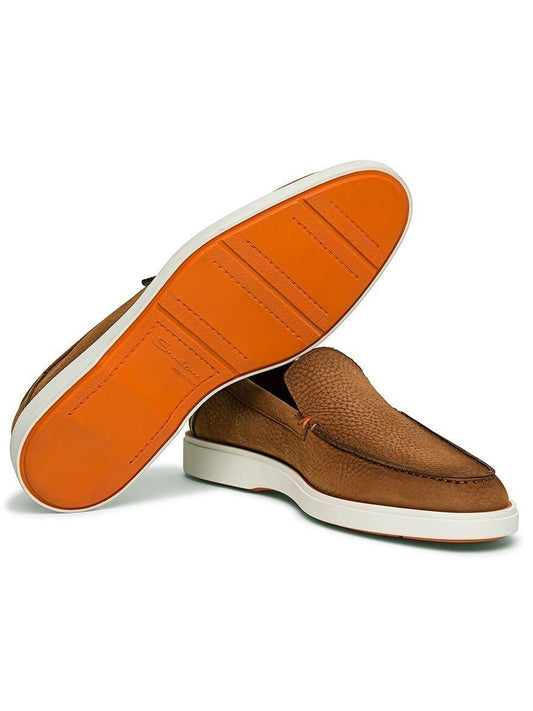 Elegant Santoni Drain Loafer in Light Brown Nubuck with white midsoles and orange rubber soles. Made in Italy, these slip-on shoes feature a nubuck upper. One shoe stands upright while the other is propped against it, showcasing the sole.