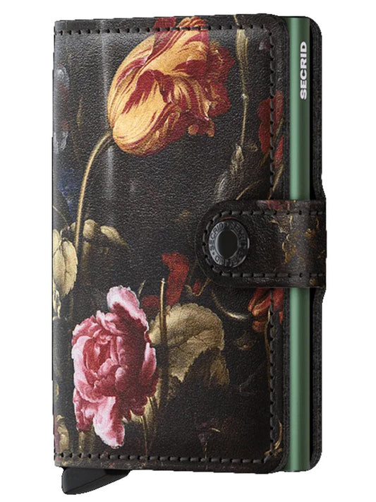 Secrid Miniwallet Art in Flowers with strap closure and brand name on the spine, featuring wireless communication protection.