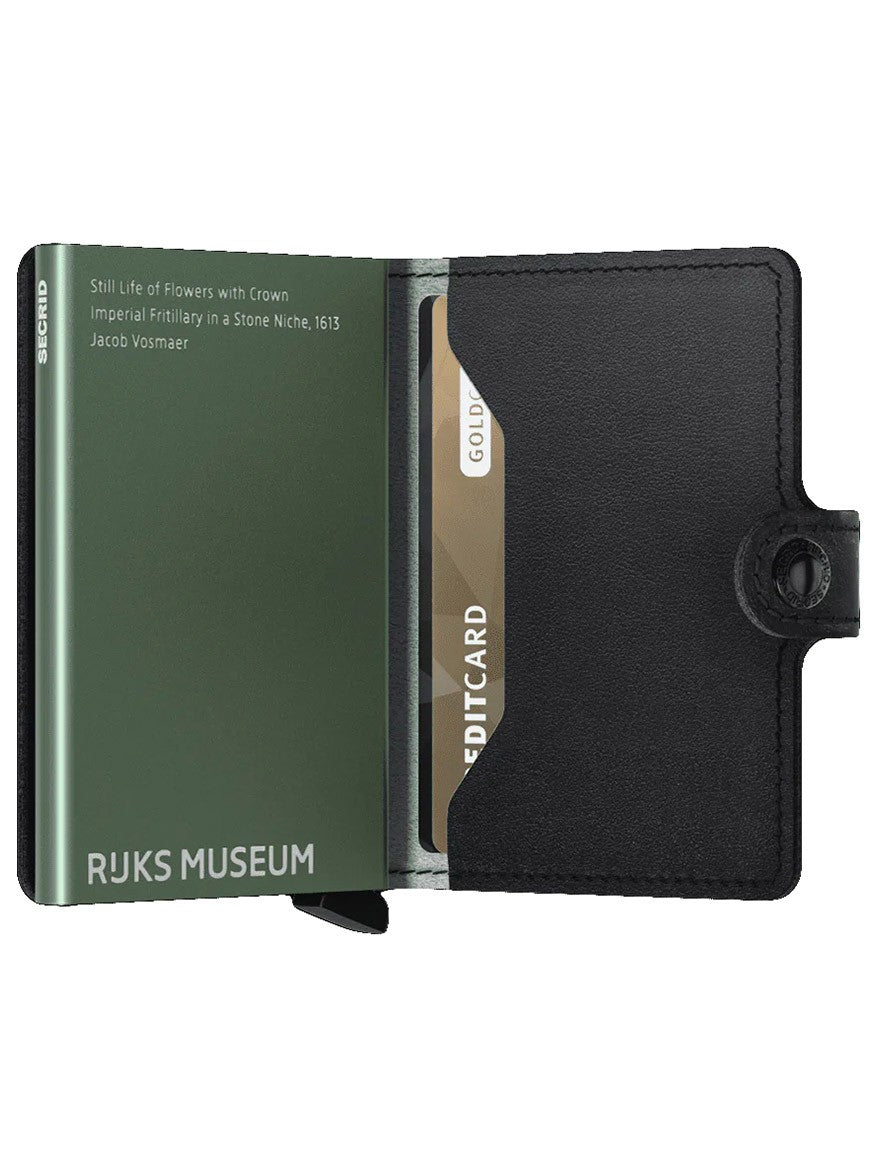 A black Secrid Miniwallet Art in Flowers with a Rijksmuseum branded card and a gold credit card, featuring wireless communication protection, inserted in the Cardprotector slots.