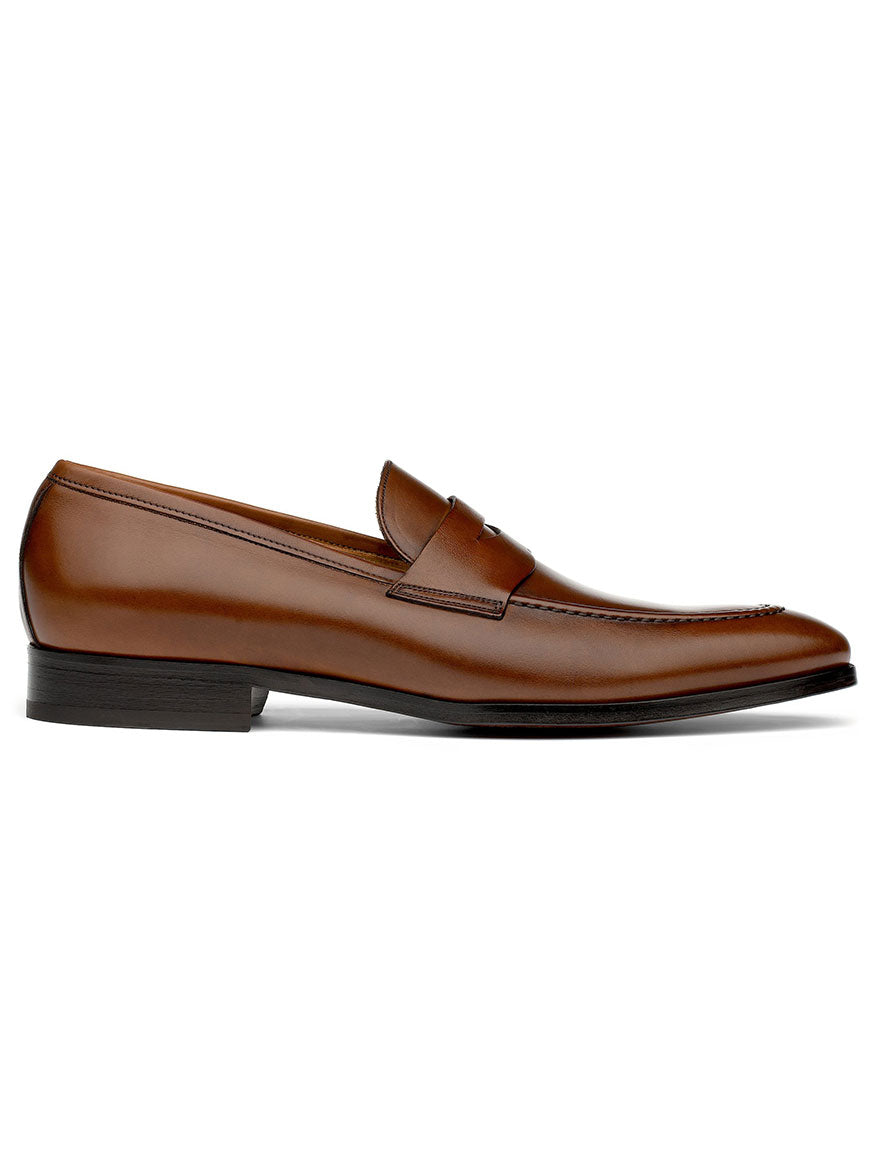 Side view of the To Boot New York Tesoro in Brandy, a single brown leather loafer with a low heel and a sleek design, featuring stitched detail on the upper, crafted by Italian artisans using premium calf hides.