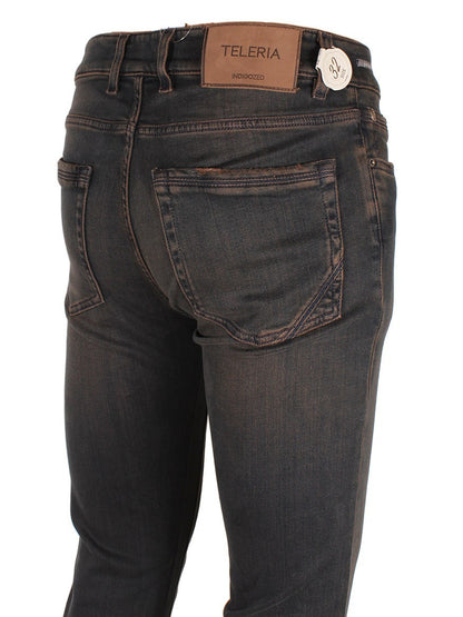 A pair of dark blue Teleria Zed Cobra Over-Dyed Stretch Denim in Desert Over displaying the back pockets and brand label.