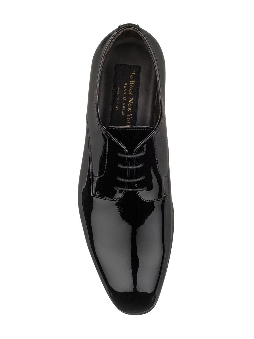 Top view of a polished leather black men's dress shoe with laces, showcasing the interior branding text "To Boot New York Aalborg in Black" and promising a modern look.