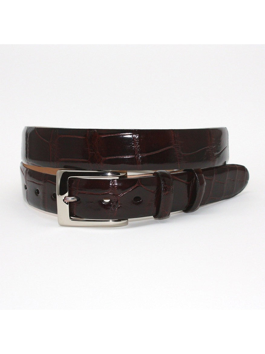 The Torino Leather American Alligator Skin Belt in Brown, made from genuine glazed American Alligator with a textured pattern and a metallic buckle, is coiled on a white background.