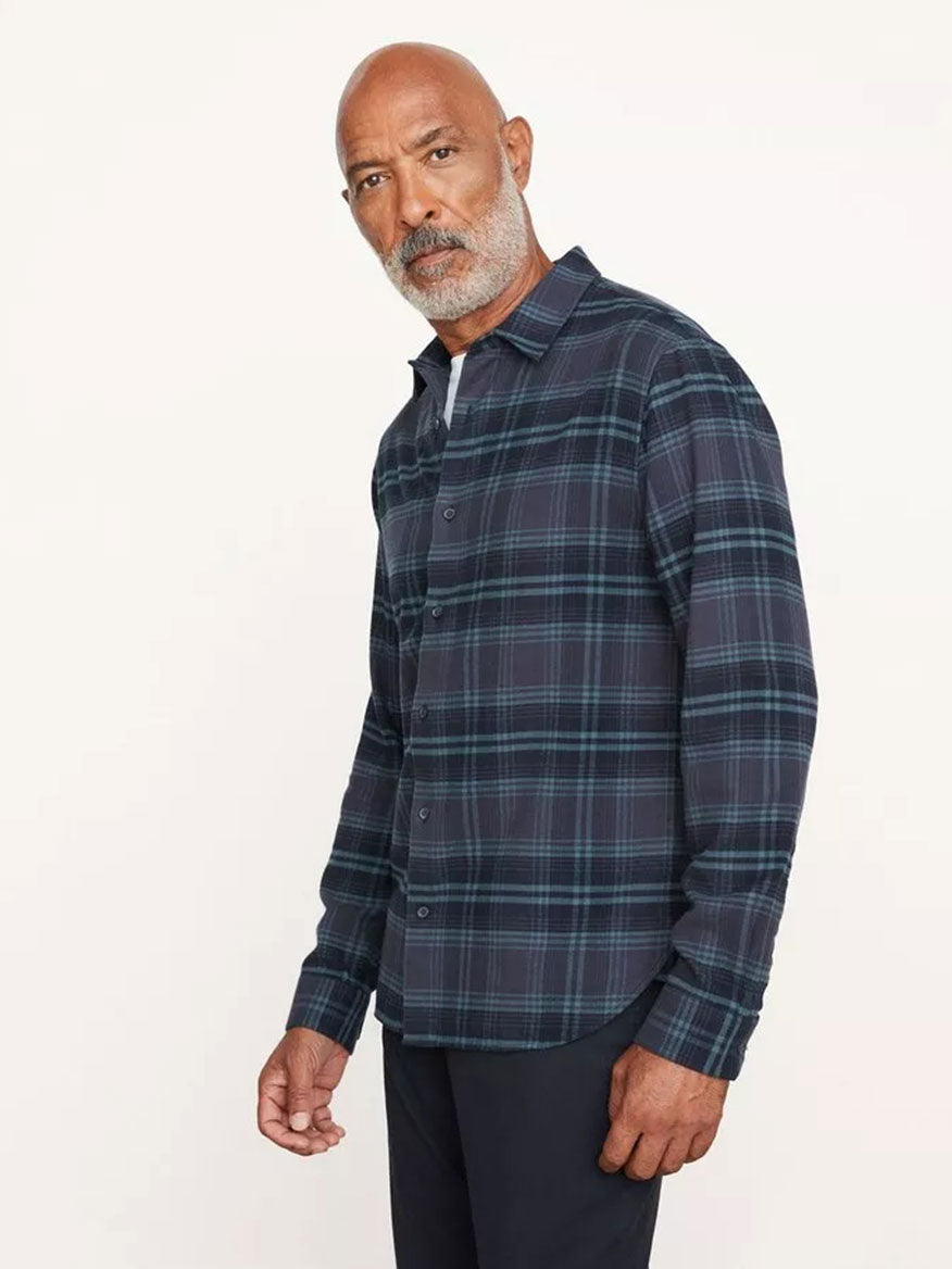 A man with a beard, wearing a Vince Westlight Plaid Long Sleeve Shirt in Nightfall and black pants, poses against a plain white background.