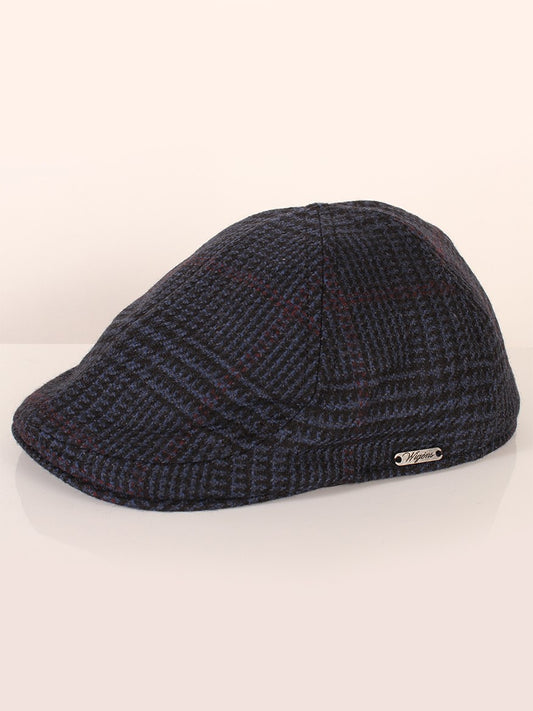 A Wigéns Pub Cap in Navy Check on a neutral background, featuring a short curved peak.