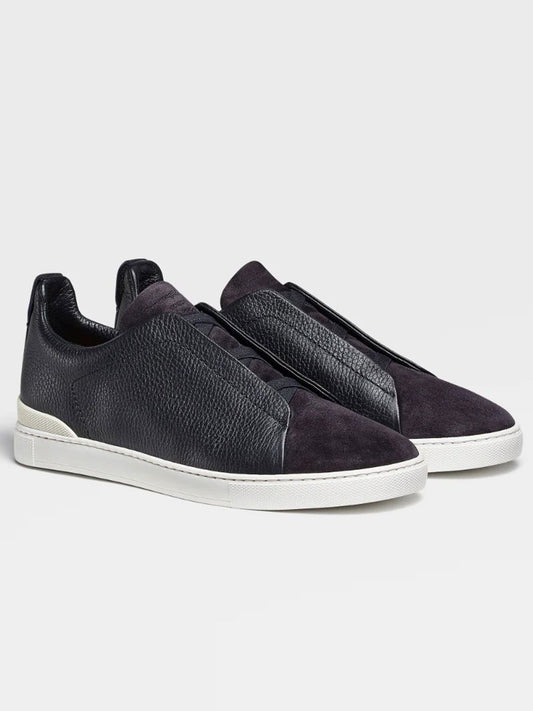 A pair of Zegna Navy Blue Grained Leather and Suede Triple Stitch™ sneakers with white soles.