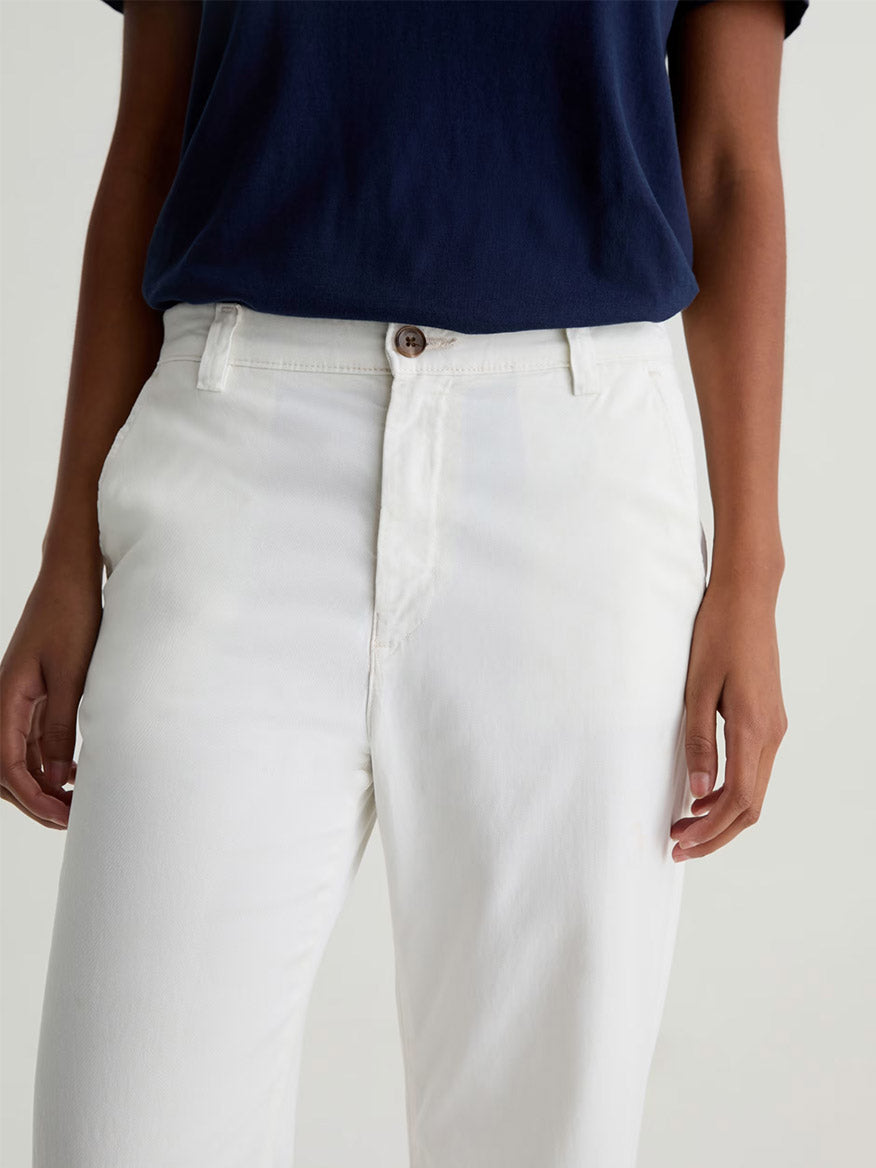 Model wearing the AG Jeans Caden Straight Leg Trouser in Powder, shown from shoulders to upper thighs against a plain background. The tailored fit showcases the comfort of Stretch Cotton Tencel Twill fabric.