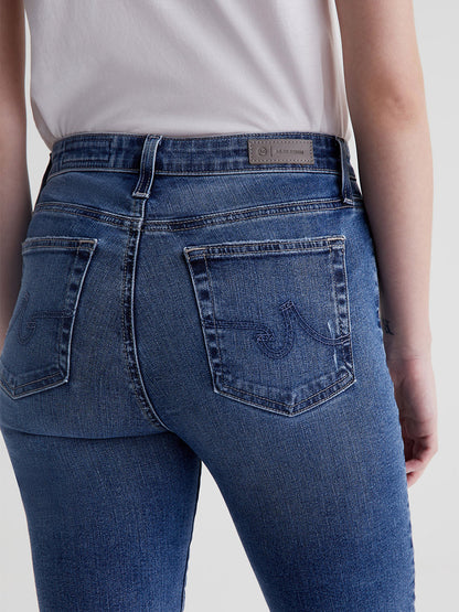 Close-up of the back of a woman wearing slim straight AG Jeans Mari High Rise Straight in 13 Years Disclosure, focusing on the fit and pockets.