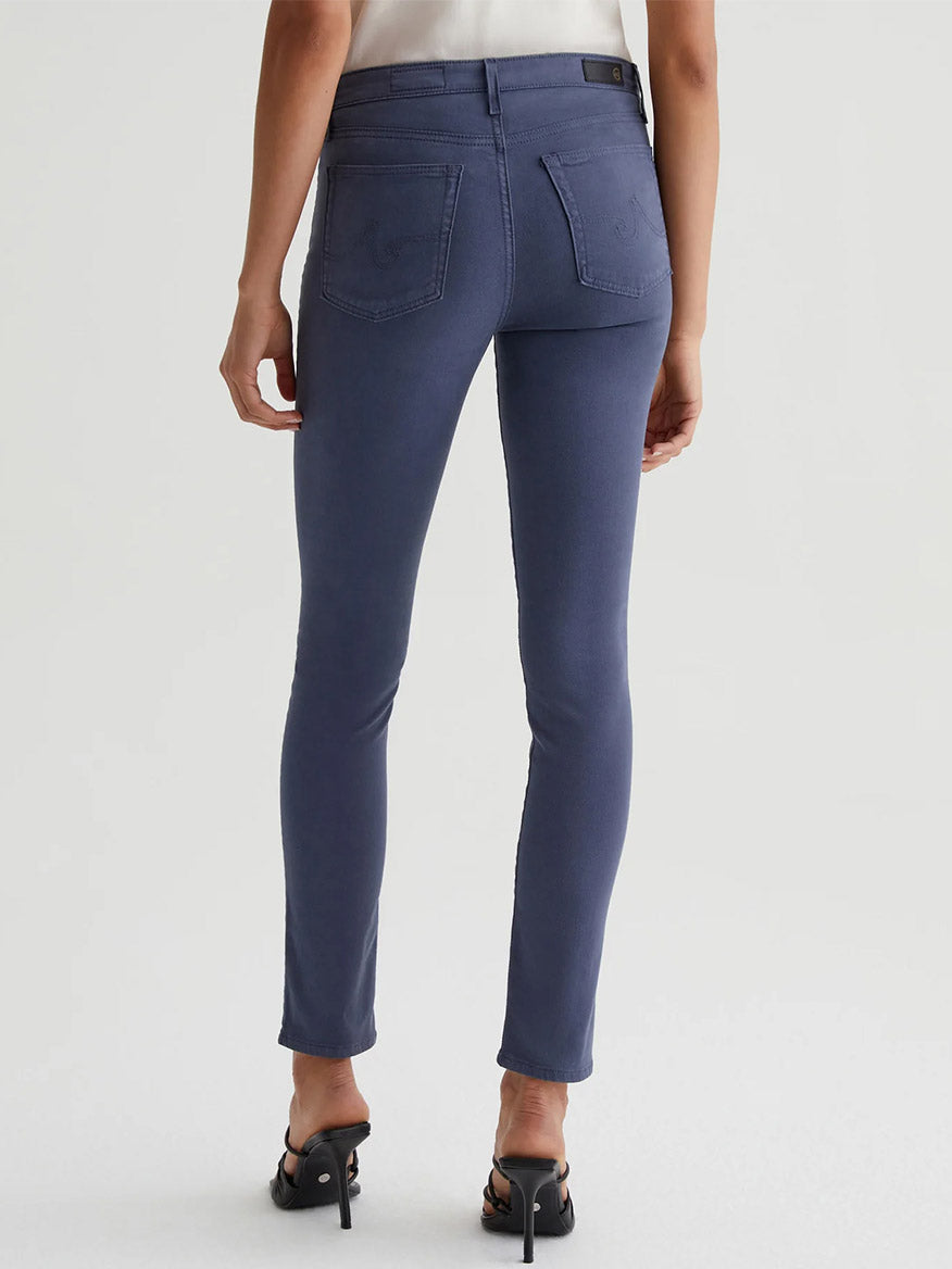 The back view of a woman wearing AG Jeans Prima Cigarette Leg in Blue Note.