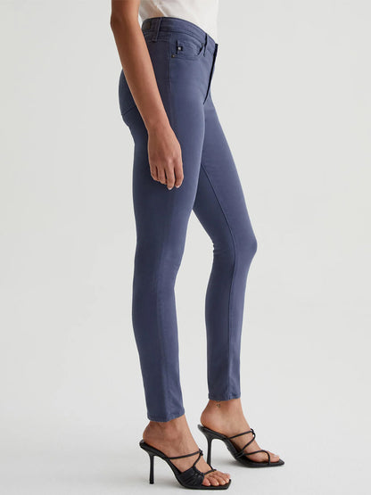 The model is wearing a pair of AG Jeans Prima Cigarette Leg in Blue Note with a fitted silhouette.