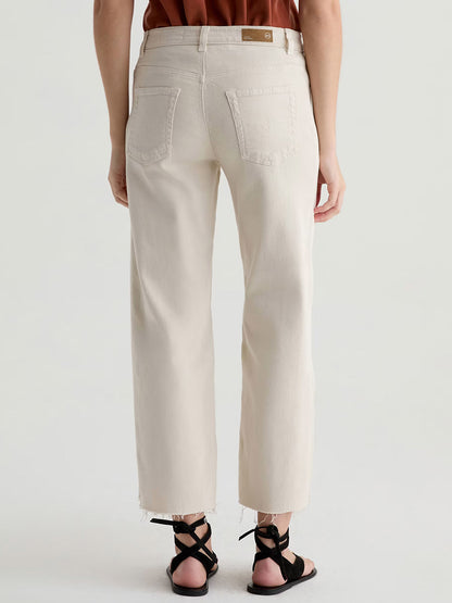 Person wearing AG Jeans Saige Wide Leg Crop With Panel in Opal Stone and black sandals, photographed from the back against a plain light background.