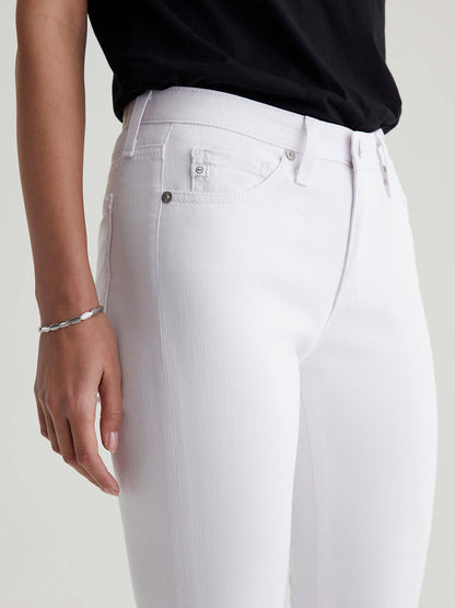 Person wearing AG Jeans Prima Cigarette Crop in White pants with a black top, focusing on the pocket detail.