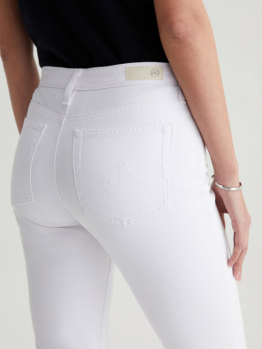 Close-up of the back of white AG Jeans Prima Cigarette Crop jeans with a focus on the pocket details.