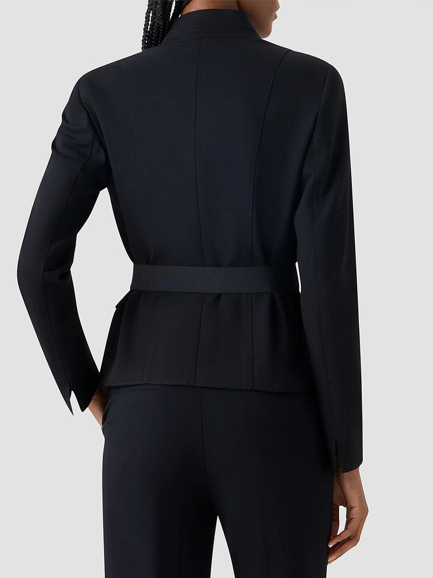 Person shown from the back, wearing the Akris Punto Belted Jacket in Black with a stand collar and removable belt, paired with matching black pants, against a plain light background.