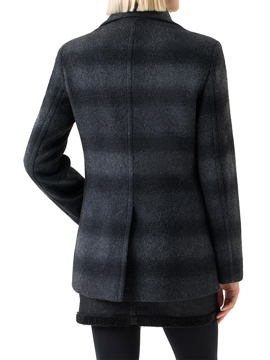 Person wearing an Akris Punto Blurred Check Wool Pea Coat in Charcoal/Black, viewed from the back, paired with a black skirt and dark pants.