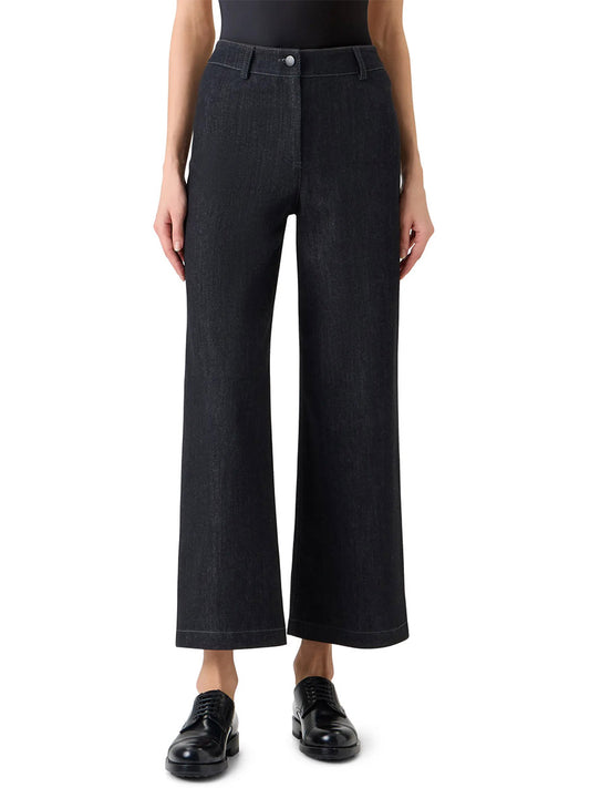 A person wears the Akris Punto Caia High-Rise Straight Leg in Black Denim with a black top and black shoes, standing against a plain white background.