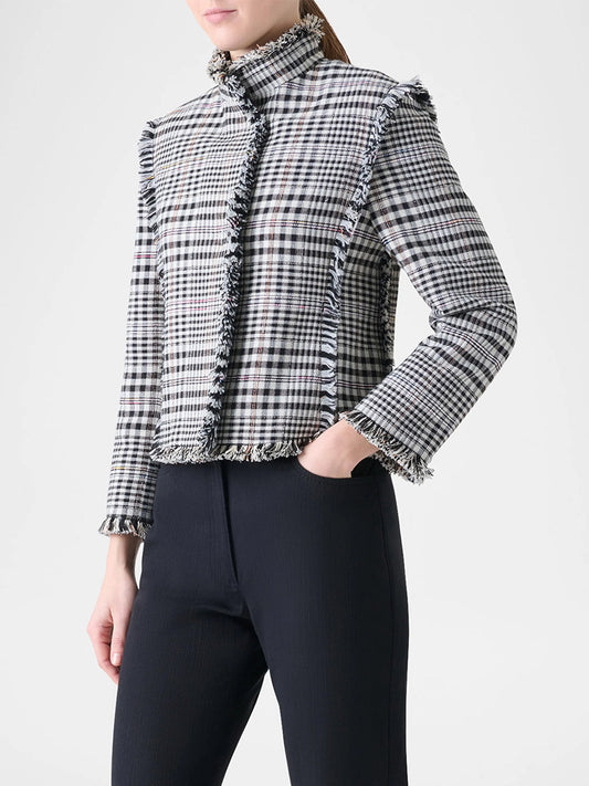 A person wears the Akris Punto Check Fringe Hem Cropped Jacket in cream/black with black pants, posing against a plain white background.