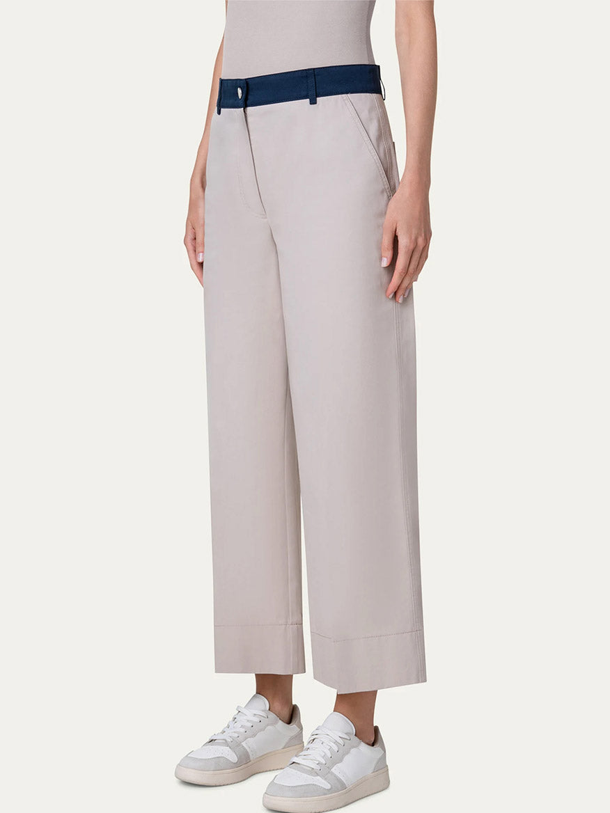 A woman wearing Akris Punto Chiara Colorblock Wide Leg Crop Pants in Beige/Navy/Orange and a white top with colorblock detailing.
