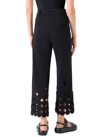 Model shown from the back wearing the Akris Punto Chieko Dropping Dot Cut Out Ankle Pant in Black, styled with a black top and flat sandals.