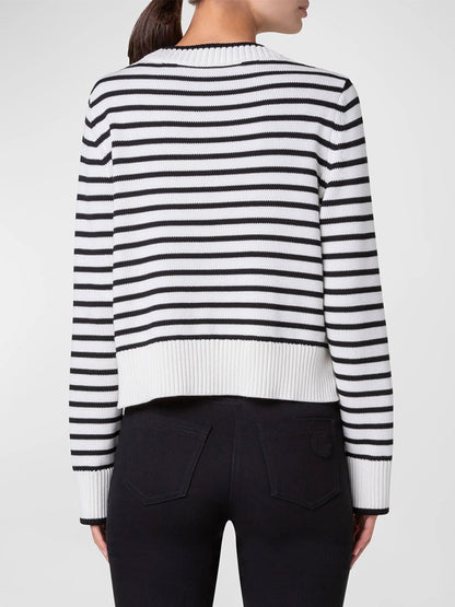 A person wearing the Akris Punto Chunky Cotton Stripe Sweater in Cream/Black with a boxy fit and black pants is shown from the back.