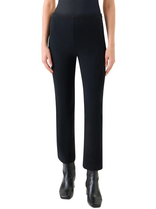 A person wears Akris Punto Elements Cindy Cropped Bootcut Pant in Black with black ankle boots, standing against a plain white background.