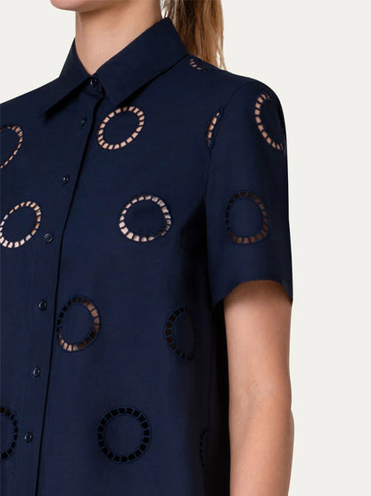 A woman wearing a blue shirt with Akris Punto Circle Eyelet Embroidery Short Sleeve Blouse in Navy.