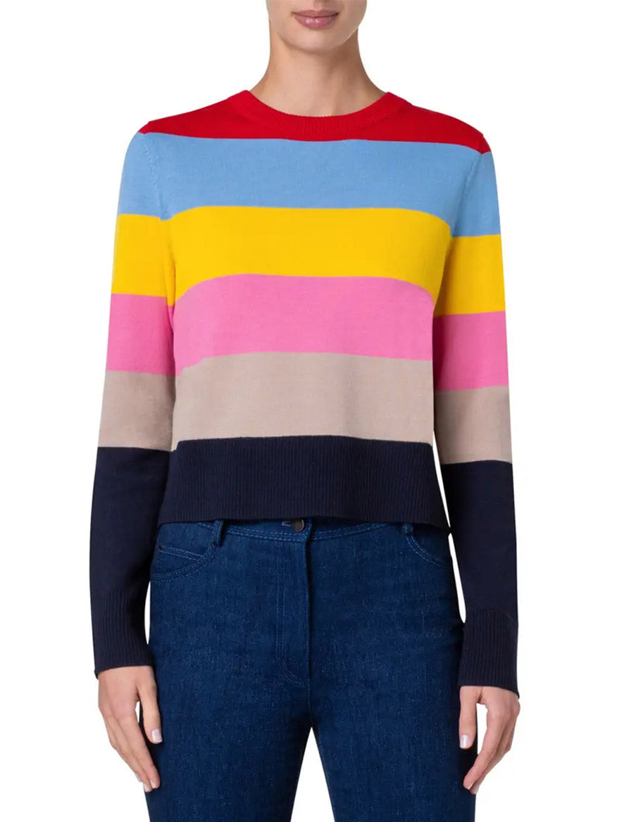 Person wearing an Akris Punto Colorblock Stripe Crewneck Sweater in Multicolor, paired with dark blue jeans.