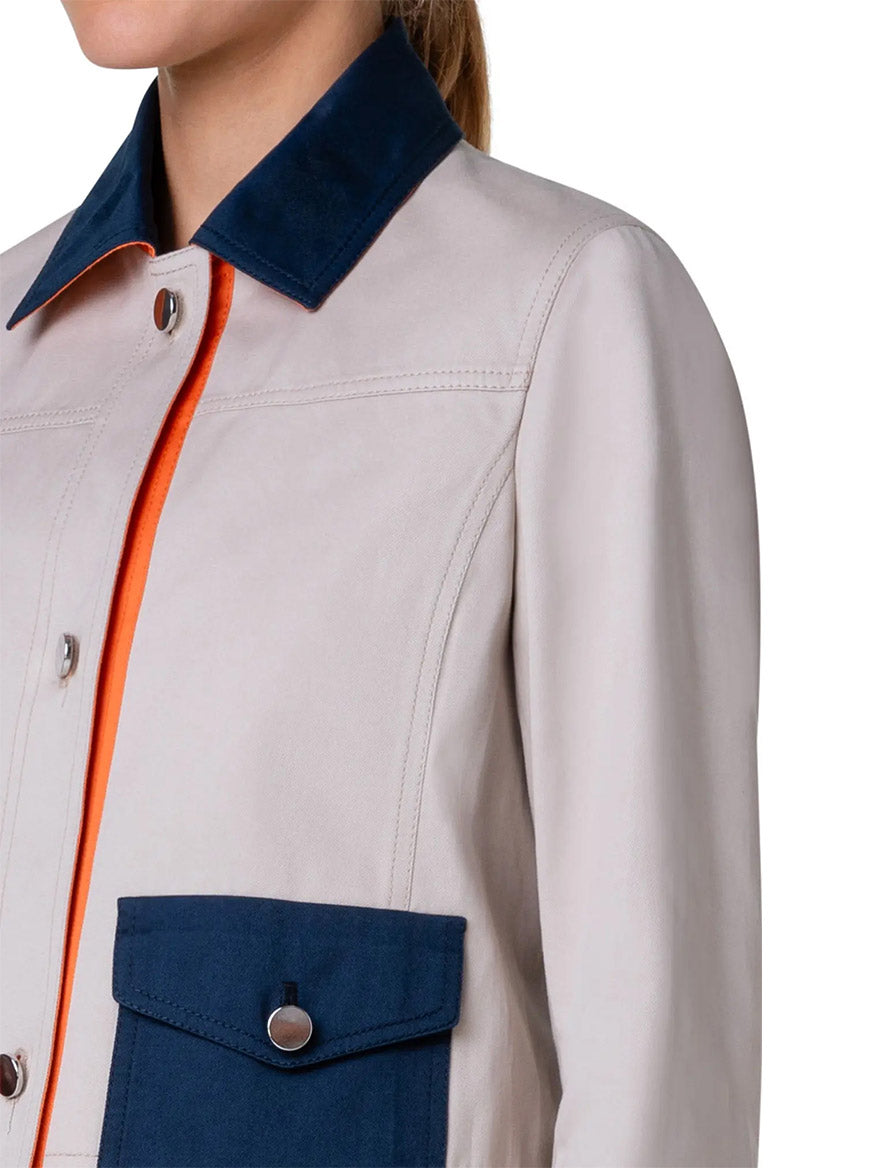 A woman wearing an Akris Punto Colorblock Crop Jean Jacket in Beige/Navy/Orange.