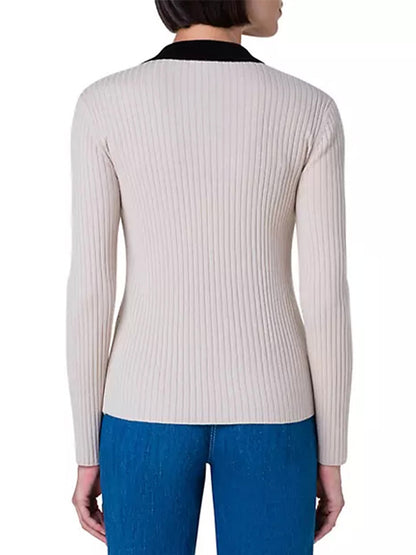 The back view of a woman wearing jeans and the Akris Punto Colorblock Rib Knit Polo in Cashew Multi.