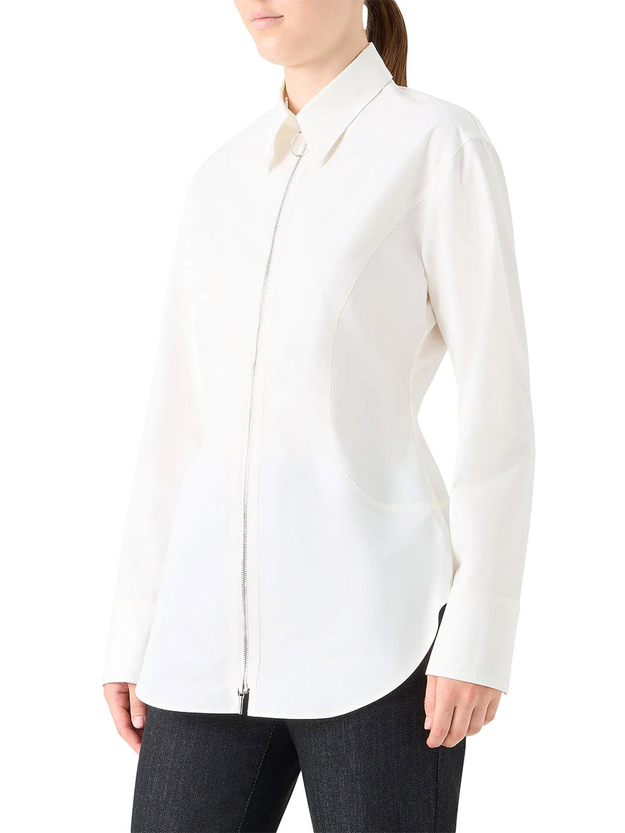 Person wearing the Akris Punto Poplin Cotton Cinched Waist Shirt in Cream, featuring a collar and long sleeves, styled with dark pants and posed sideways to the camera.