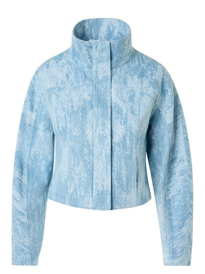 The Akris Punto Washed Jacquard Denim Jacket in Sky Blue features a mock neck collar, long sleeves, and a subtle textured pattern with a concealed front closure.