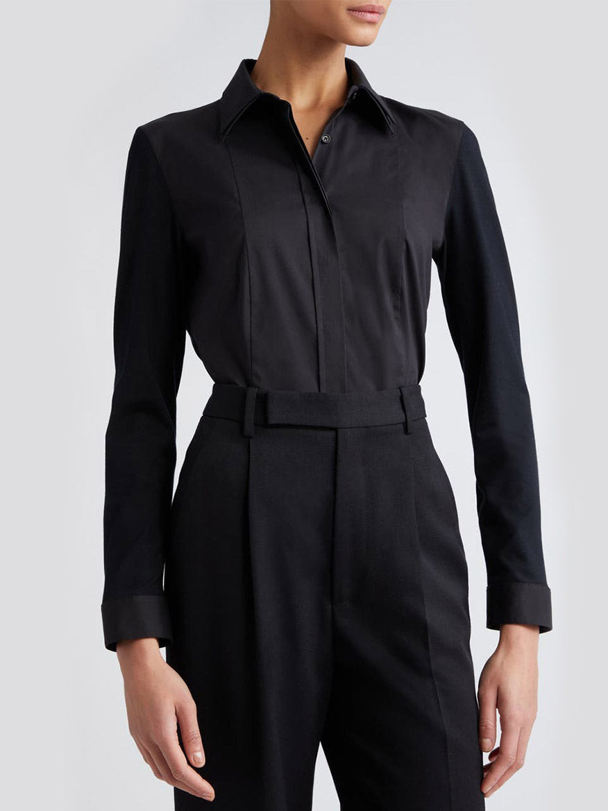 A woman wearing an Akris Punto Double Collar Jersey Back Shirt in Black and trousers from Akris Punto.