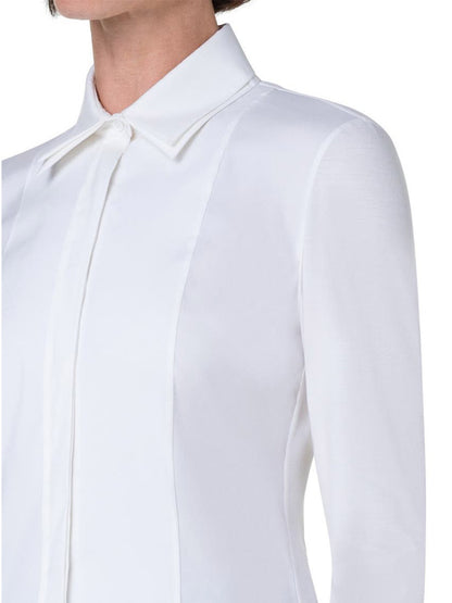The modern mood is captured as a woman elegantly dons the Akris Punto Double Collar Jersey Back Shirt in Cream.