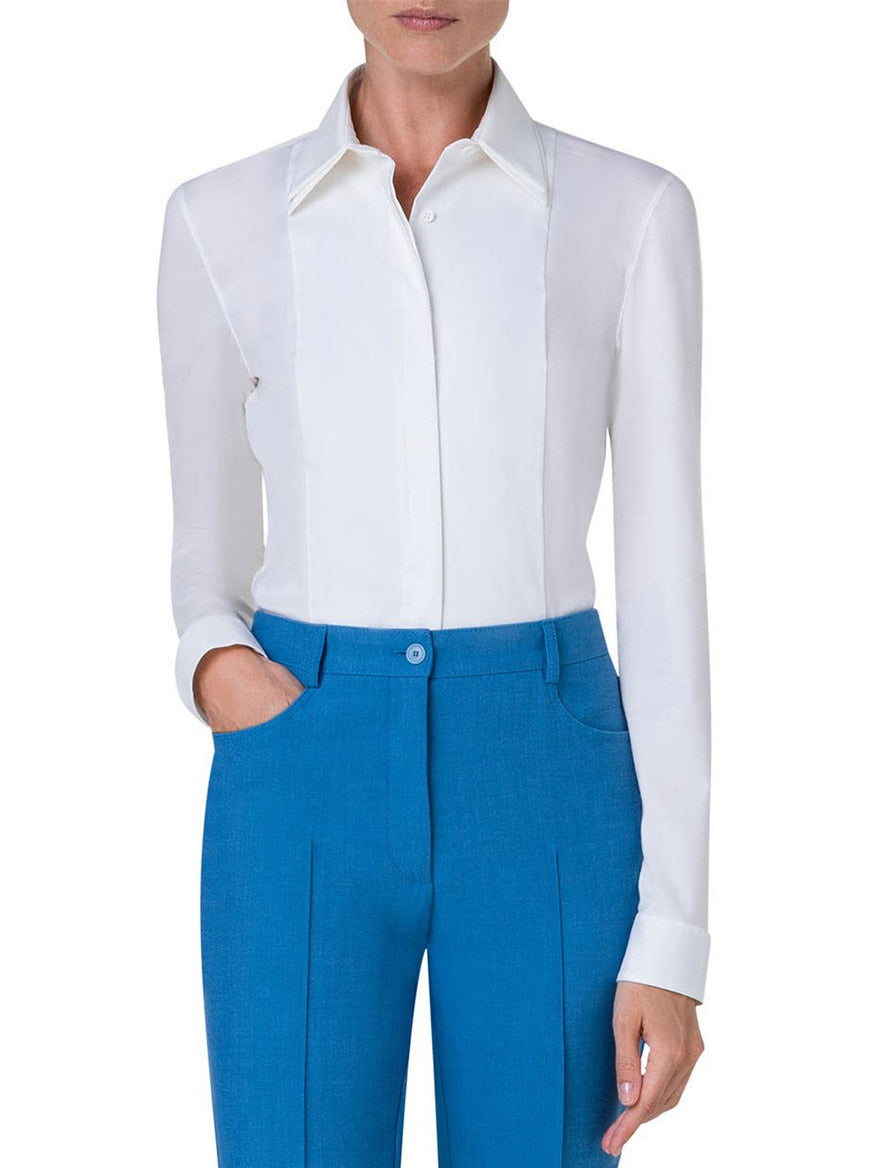 A modern Akris Punto Double Collar Jersey Back Shirt in Cream woman in blue pants.