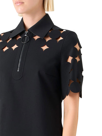 A close-up of the Akris Punto Dropping Dot Cut Out Polo in Black, showcasing its pointed collar and sleek cut-out jersey details.