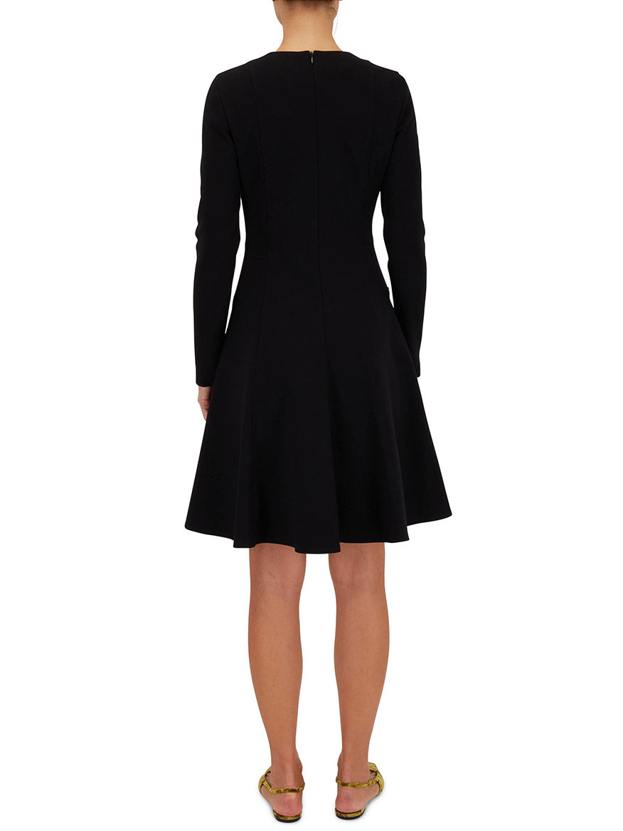 The back view of a woman wearing an Akris Punto Elements Long Sleeve Fit & Flare Dress in Black with a signature dot motif.