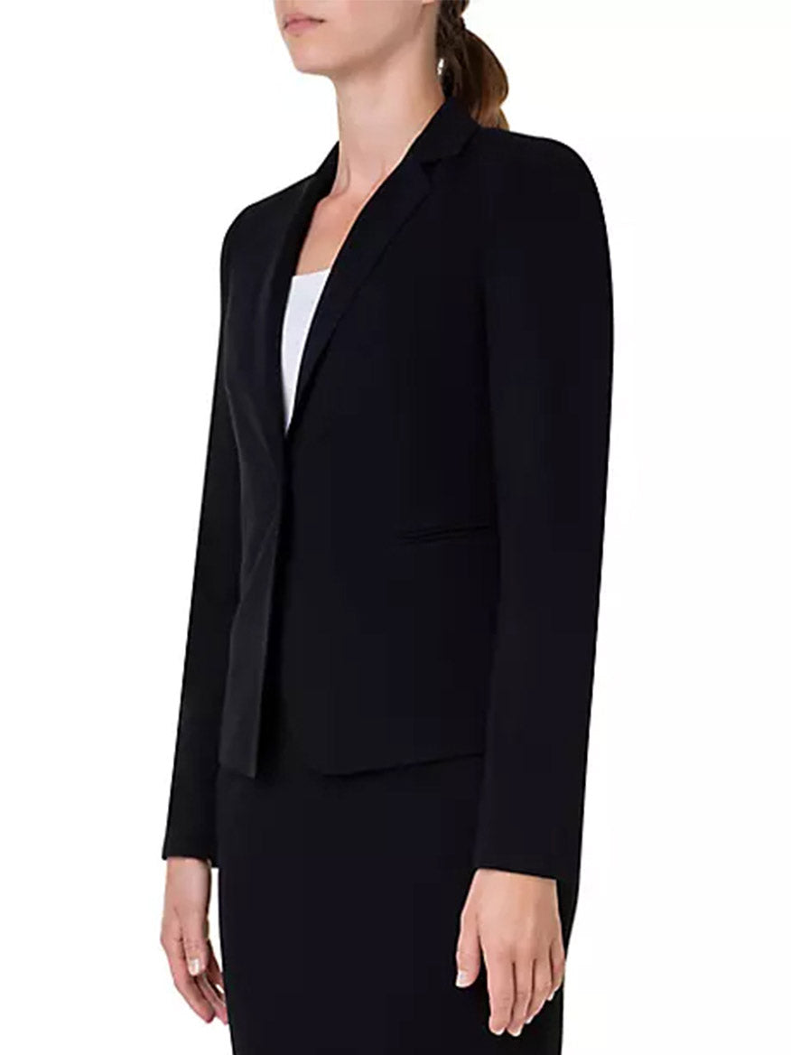 A woman wearing an Akris Punto Elements One-Button Jersey Blazer in Black and skirt.