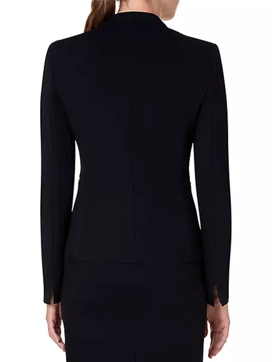 The back view of a woman wearing an Akris Punto Elements One-Button Jersey Blazer in Black.