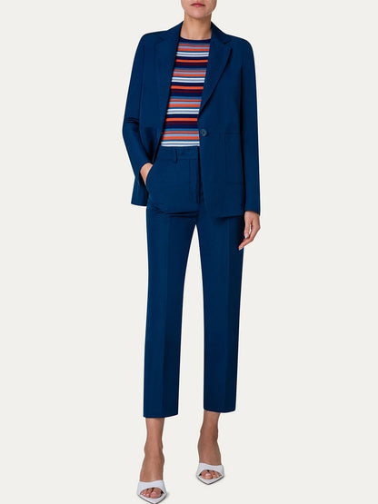 The model is wearing a blue suit with tapered-leg silhouette and Akris Punto Feryn Linen Tapered Pants in Ink tee.