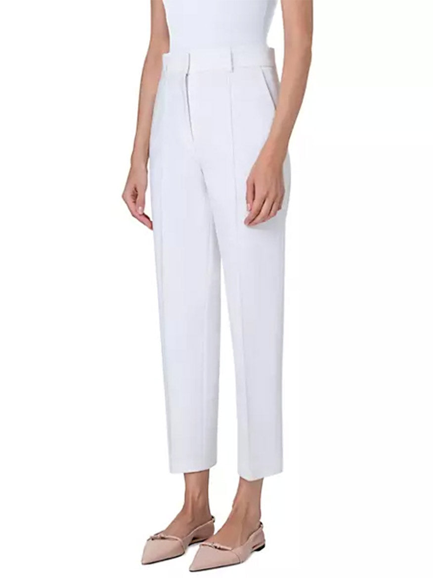 A woman wearing Akris Punto Ferry Tapered Ankle Pants in Cream and a jersey top.