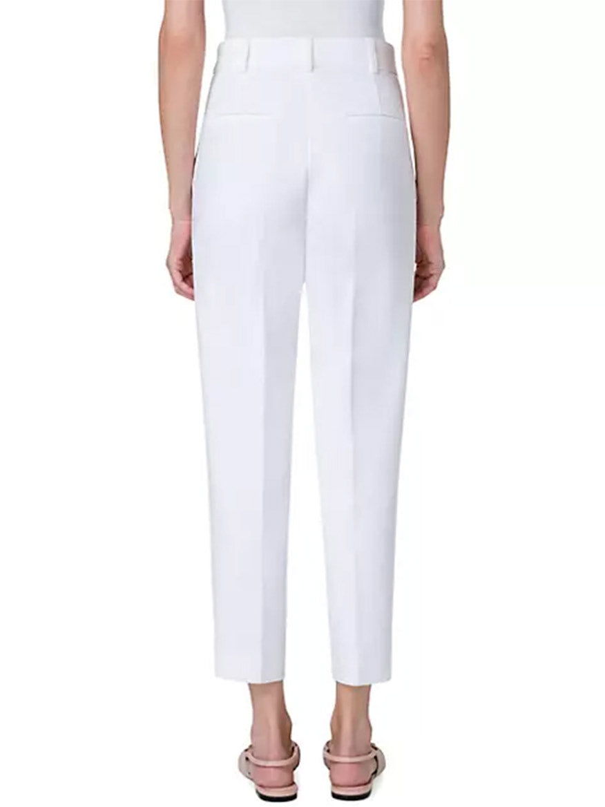 The back view of a woman wearing Akris Punto Ferry Tapered Ankle Pants in Cream.