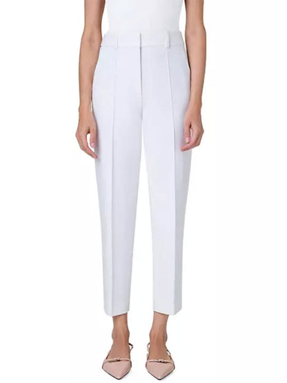 A woman wearing Akris Punto Ferry Tapered Ankle Pants in Cream and a white top.