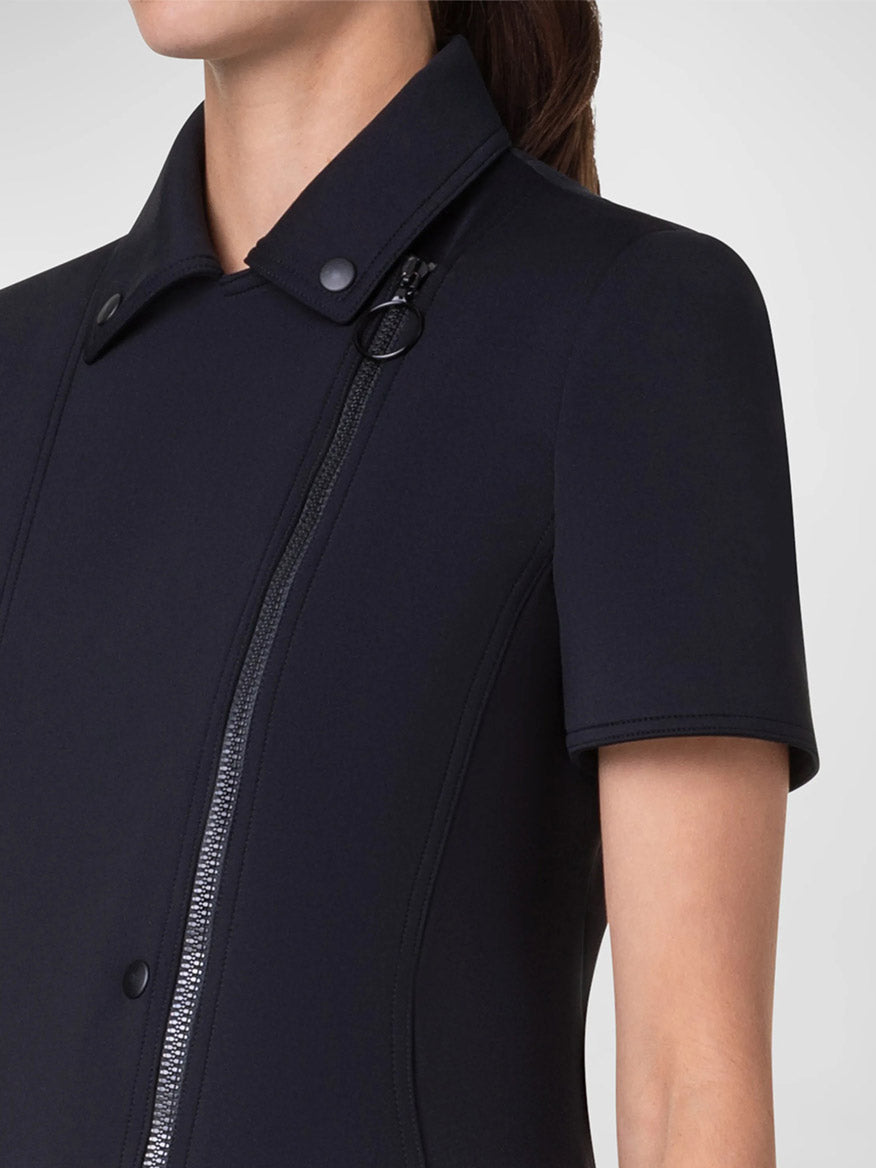 A person is wearing an Akris Punto Elbow Sleeve Neoprene Biker Jacket in Black. The person's face is not visible.