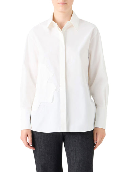A person wearing the Akris Punto XL Pop Dot Flower Applique Button Down Blouse in cream with black pants, standing against a plain background.