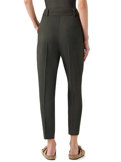 A person shown from the back wears Akris Punto Fred Belted High Rise Ankle Pants in olive, featuring a tapered silhouette and belt loops, paired with flat shoes.